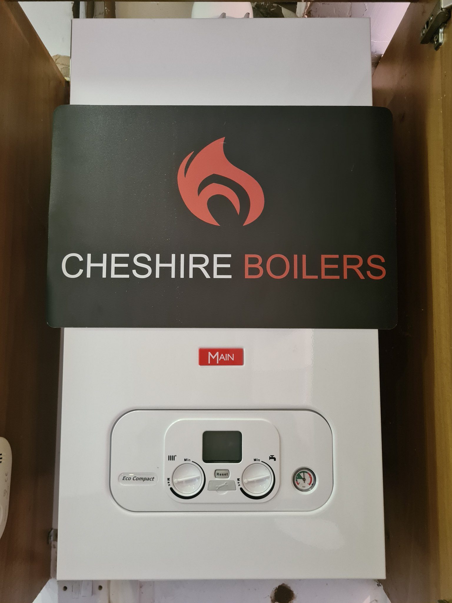 A new combi boiler and copper pipework fitted in a cupboard